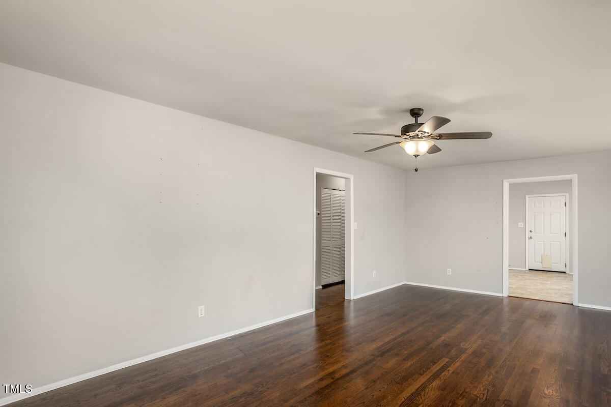 4912 Auburn Road Raleigh, NC 27609 - Photo 9 of 23 a view of an empty room with wooden floor