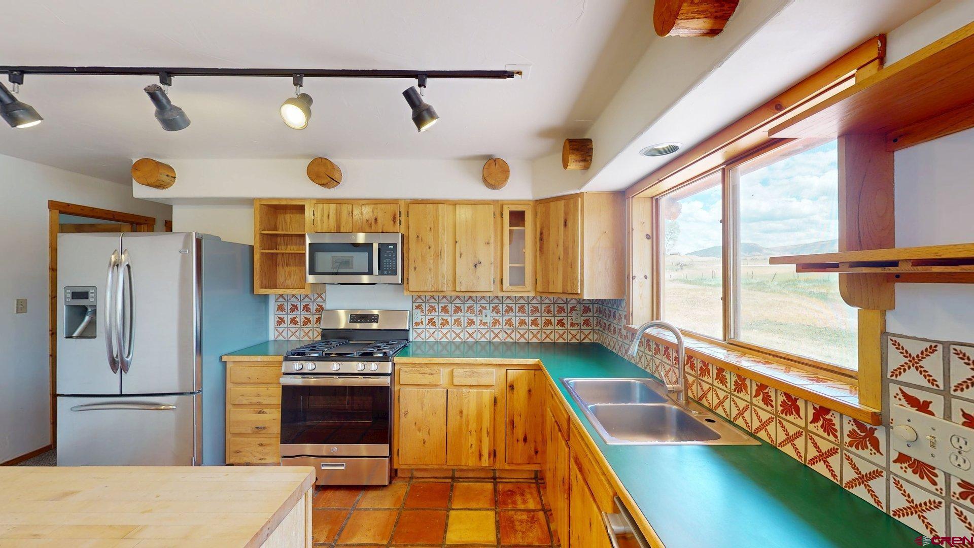 40557 M75 Road Paonia, CO 81428 - Photo 7 of 34 a kitchen with stainless steel appliances granite countertop a refrigerator and a stove