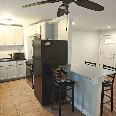 a kitchen with a refrigerator and a sink