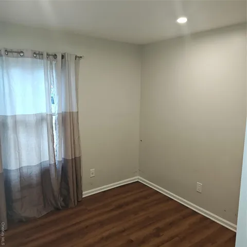 an empty room with wooden floor