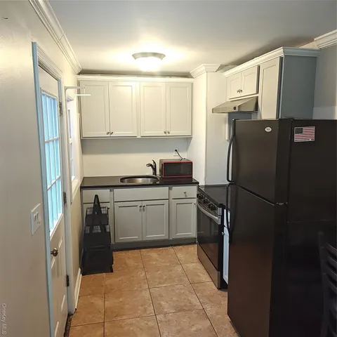 a kitchen with a refrigerator and a sink