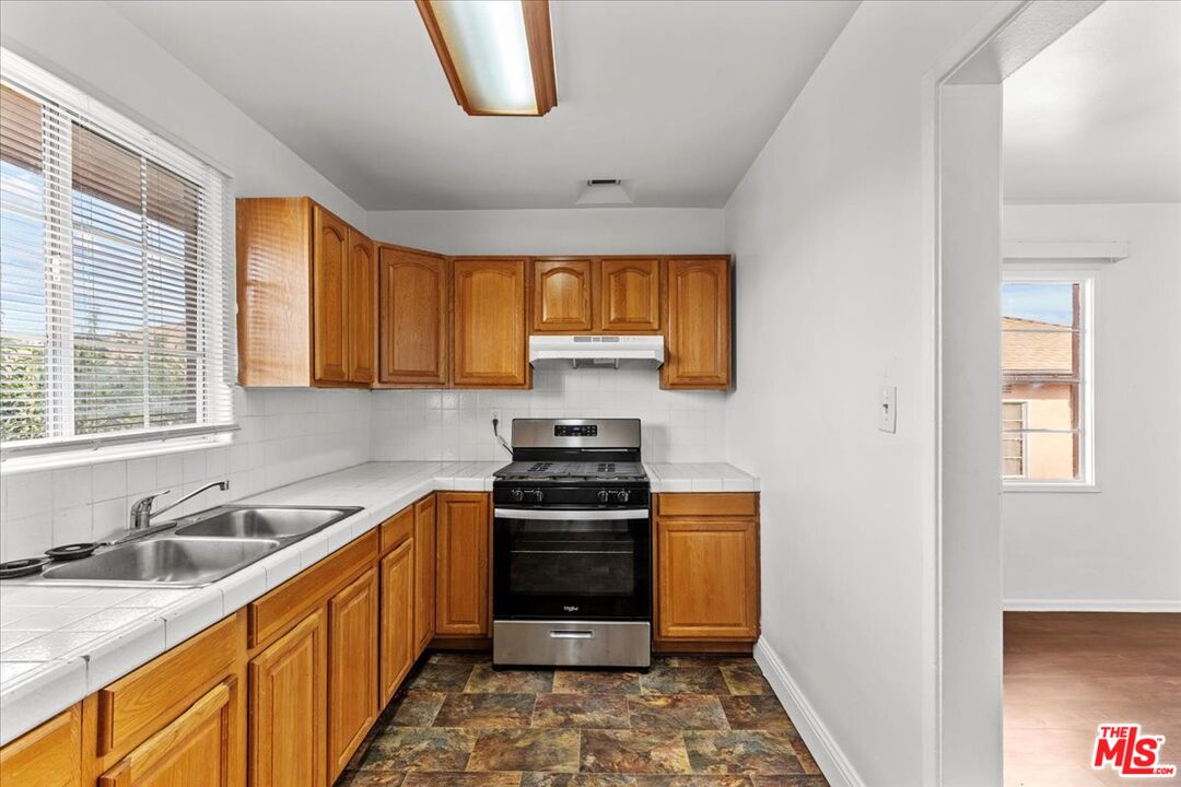 4045 Abourne Road, Unit D Los Angeles, CA 90008 - Photo 2 of 17 a kitchen with a sink stove top oven and a window