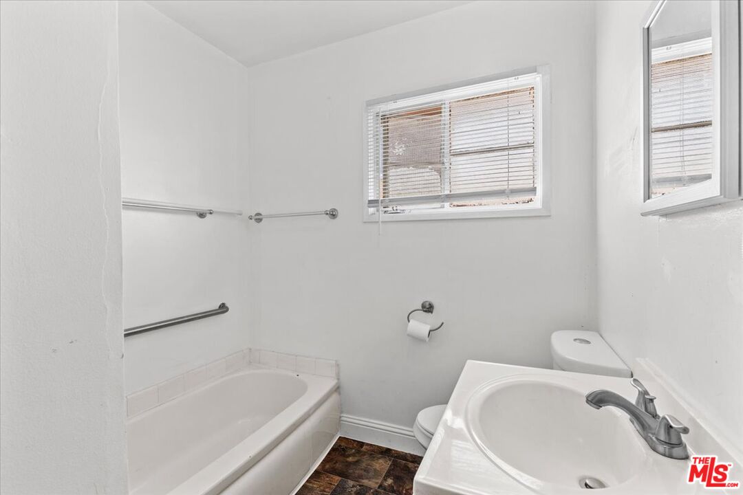 4045 Abourne Road, Unit D Los Angeles, CA 90008 - Photo 6 of 17 a white bath tub sitting next to a white toilet and sink