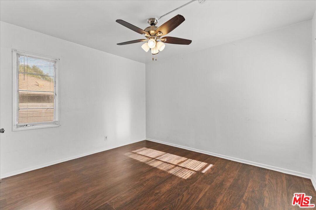4045 Abourne Road, Unit D Los Angeles, CA 90008 - Photo 9 of 17 an empty room with wooden floor and windows
