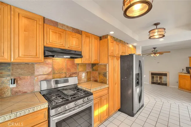 a kitchen with stainless steel appliances a refrigerator and a sink