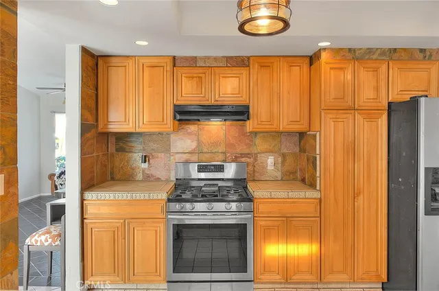 a large kitchen with a large window appliances and cabinets