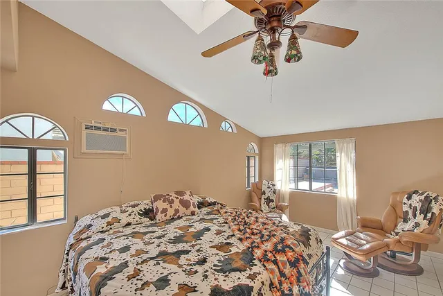 a bedroom with natural light and a bed