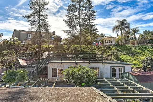 a view of a patio with table and chairs and potted plants