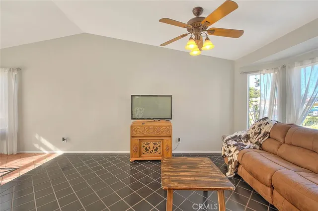 a living room with a bed furniture and a window
