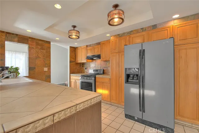 a kitchen with a stove and a refrigerator
