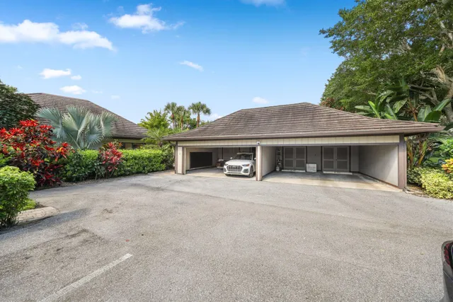 a front view of a house with a yard and a garage