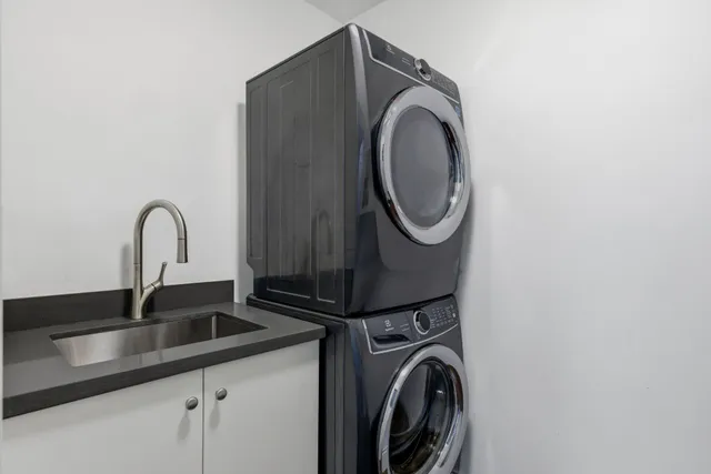 a bedroom with a bed a table and a flat screen tv