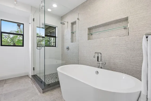 a living room with furniture and large windows