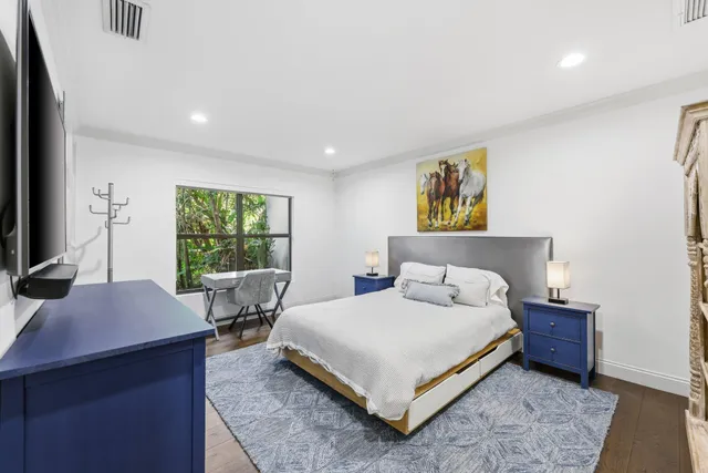 a view of a patio with couches chairs dining table and chairs barbeque grill with a small yard