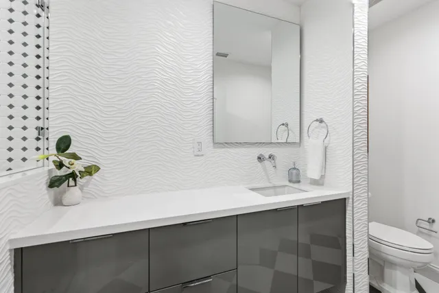 an aerial view of a houses with a yard and lake view