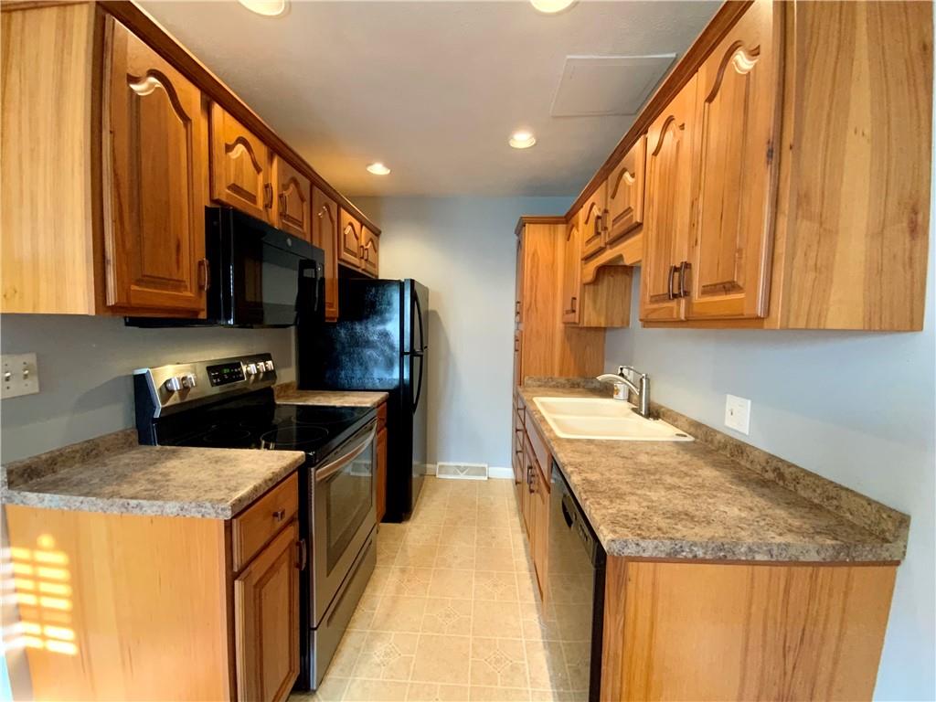 380 3rd Street, Unit 380 Beaver, PA 15009 - Photo 11 of 25 a kitchen with stainless steel appliances granite countertop a stove a sink and a microwave