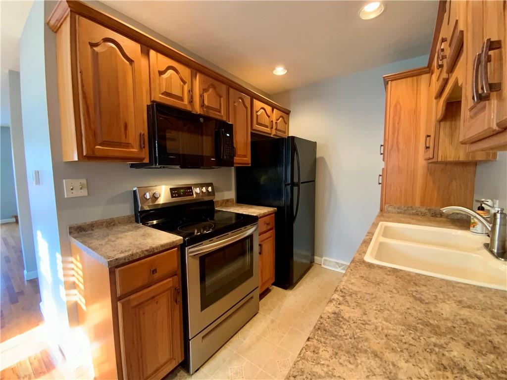 380 3rd Street, Unit 380 Beaver, PA 15009 - Photo 12 of 25 a kitchen with stainless steel appliances granite countertop a stove a sink and a microwave