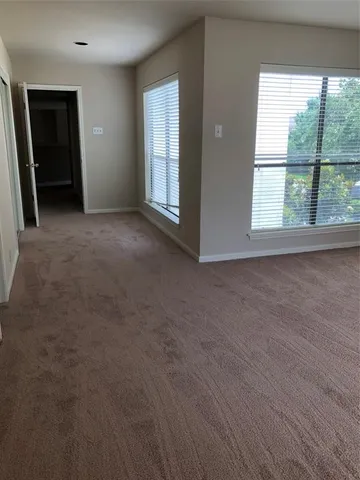 a view of empty room with floor to ceiling window