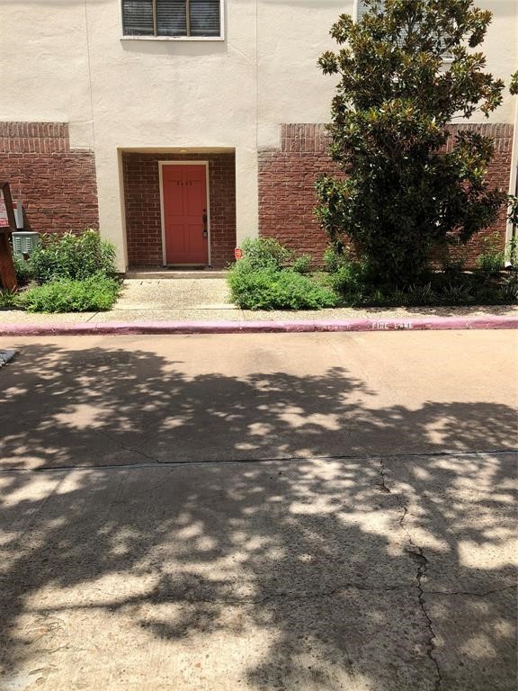 2438 Bering Drive, Unit 2438 Houston, TX 77057 - Photo 16 of 19 a front view of a house with a yard
