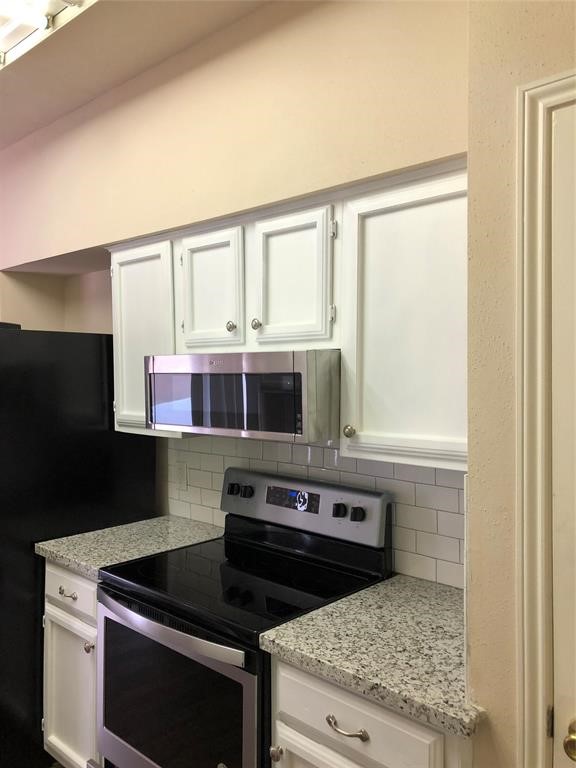 2438 Bering Drive, Unit 2438 Houston, TX 77057 - Photo 6 of 19 a kitchen with a stove and a microwave
