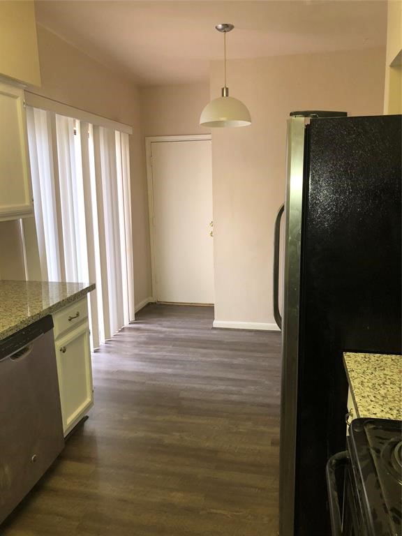 2438 Bering Drive, Unit 2438 Houston, TX 77057 - Photo 7 of 19 wooden floor in an empty room with a window