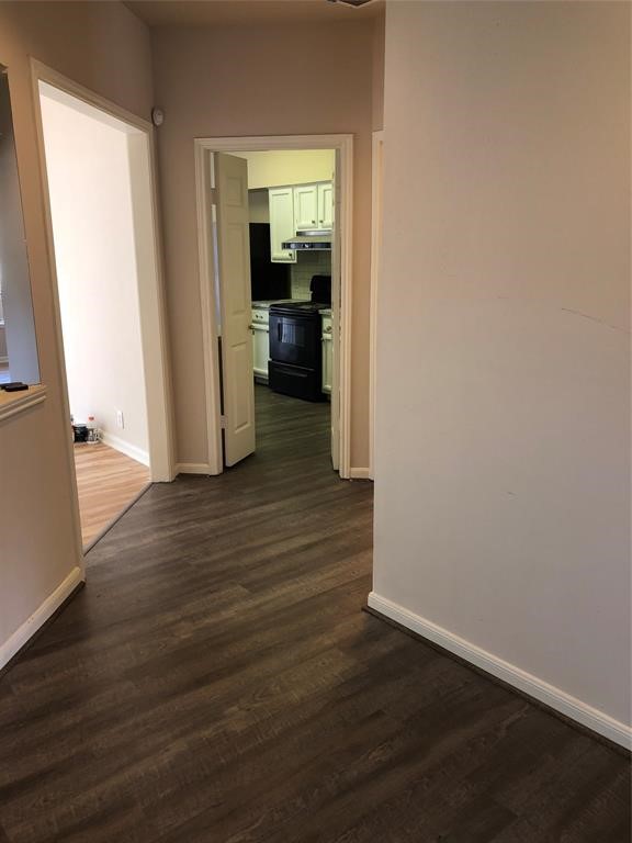 2438 Bering Drive, Unit 2438 Houston, TX 77057 - Photo 10 of 19 a view of a hallway with wooden floor and a cabinet