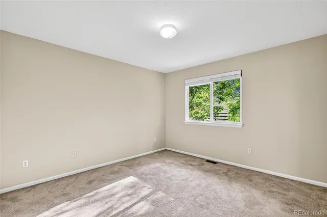 an empty room with windows and closet