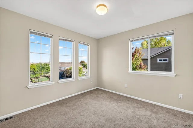 an empty room with closet and a chandelier fan