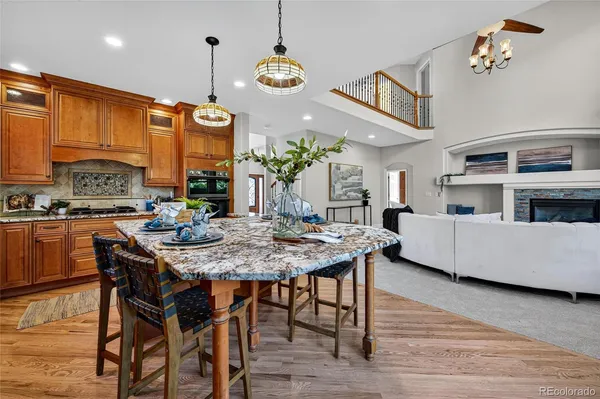 a view of a dining room with furniture a chandelier window and wooden floor