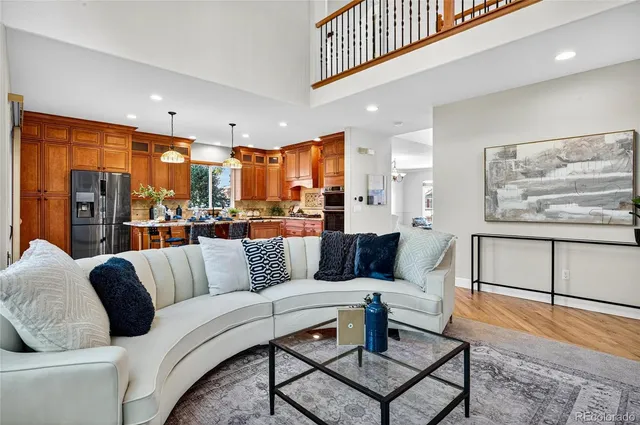 a living room with furniture large window and a table