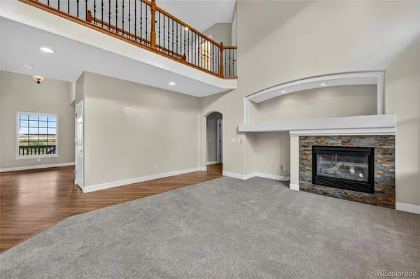a dining room with furniture a chandelier and window