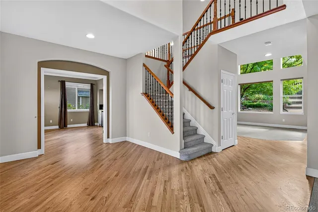 a dining room with furniture a chandelier and window