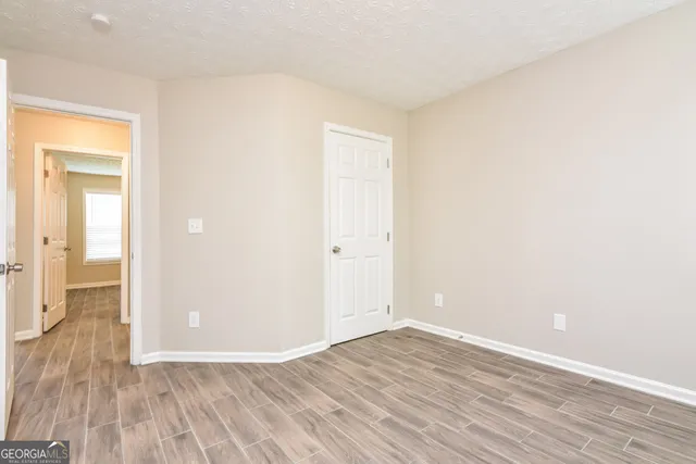 a view of an empty room with wooden floor