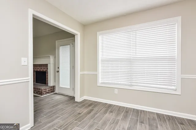 an empty room with wooden floor and a window