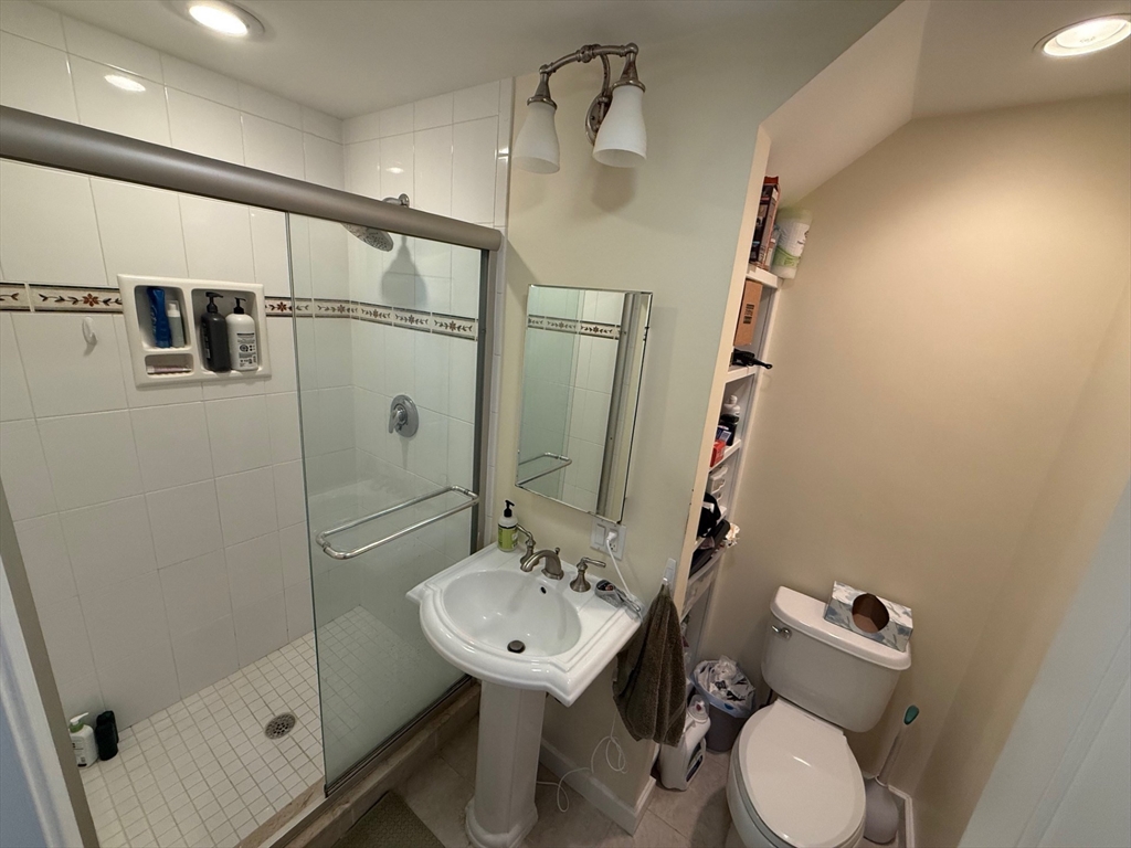 72 Bennett Street, Unit 72 Boston, MA 02135 - Photo 12 of 17 a bathroom with a sink mirror toilet and shower