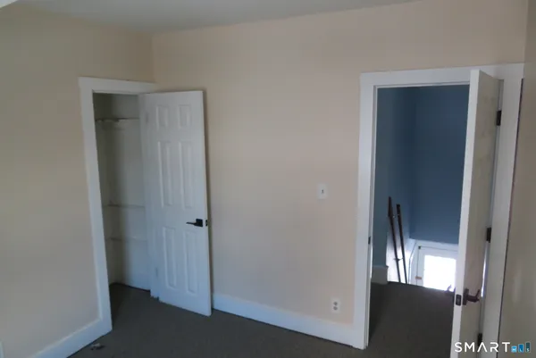 a view of a hallway with closet area