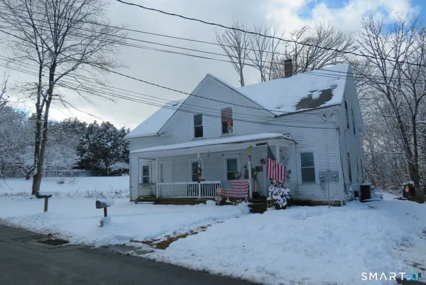 a view of a house with a snow in the road