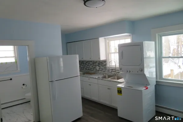 a kitchen with a refrigerator sink and window