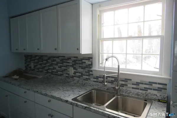 a kitchen with a sink cabinets and window
