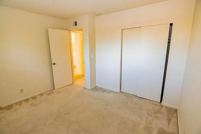 a view of a swimming pool with lawn chairs and a big yard