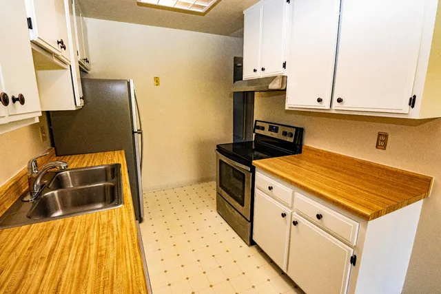 a kitchen with a sink stove and refrigerator