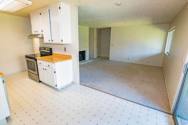 a view of a kitchen with microwave and cabinets