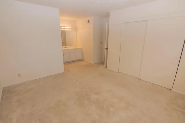 a bathroom with a double vanity sink toilet and shower