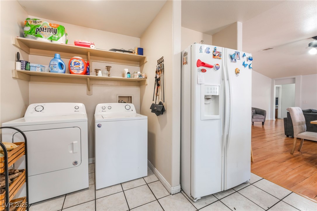 4656 East Desert Inn Road Las Vegas, NV 89121 - Photo 70 of 98 4652 E DI Laundry room with light tile patterned floors and washing machine and dryer