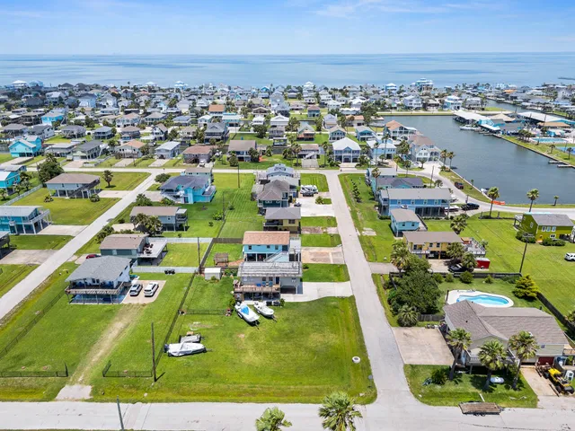 a aerial view of a house with swimming pool lawn chairs and a yard