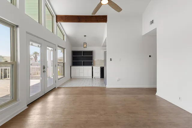 a view of empty room with wooden floor