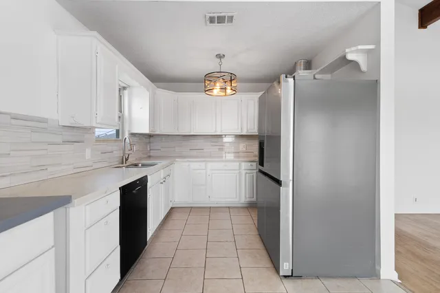 a kitchen with a sink cabinets and stainless steel appliances