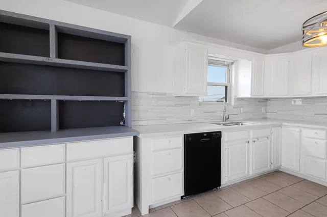 a kitchen with stainless steel appliances granite countertop a sink and a stove