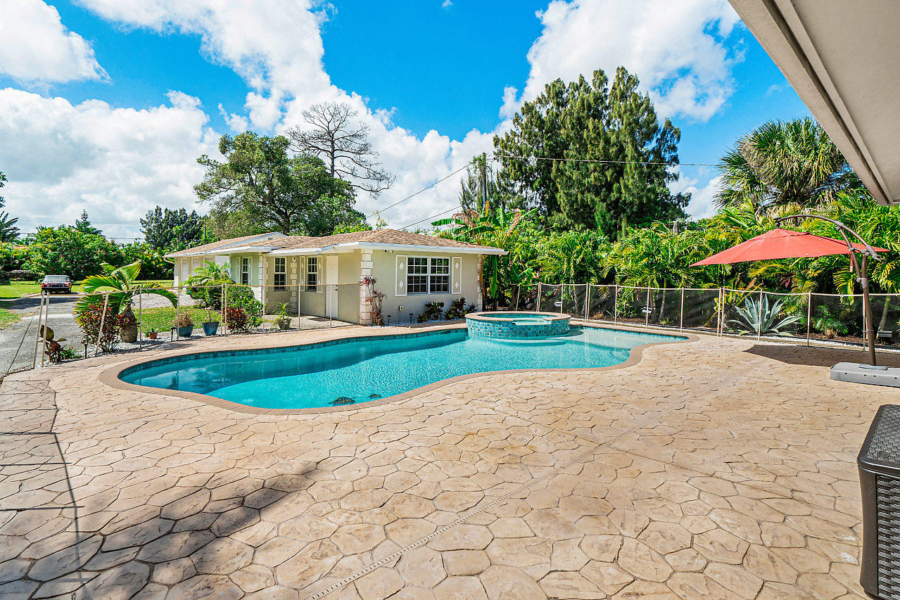 3605 Gulfstream Road Palm Springs, FL 33461 - Photo 11 of 35 a view of a house with a swimming pool