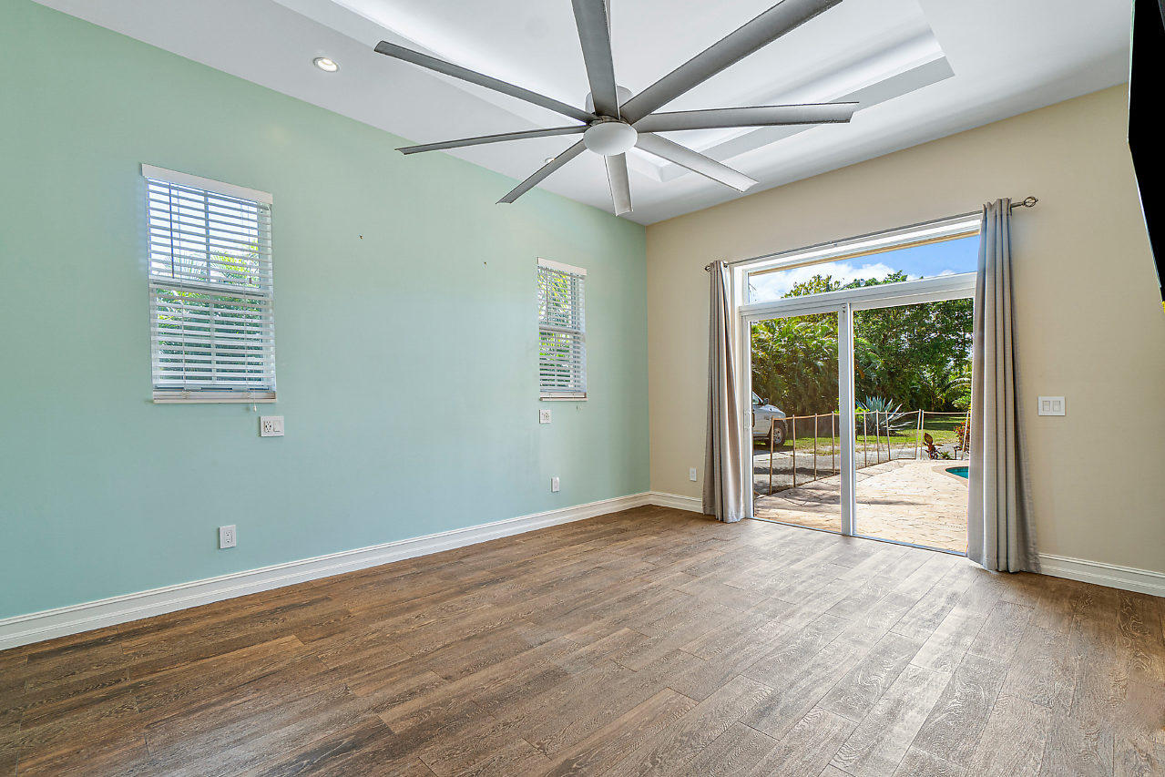 3605 Gulfstream Road Palm Springs, FL 33461 - Photo 12 of 35 a view of an empty room with a window and wooden floor